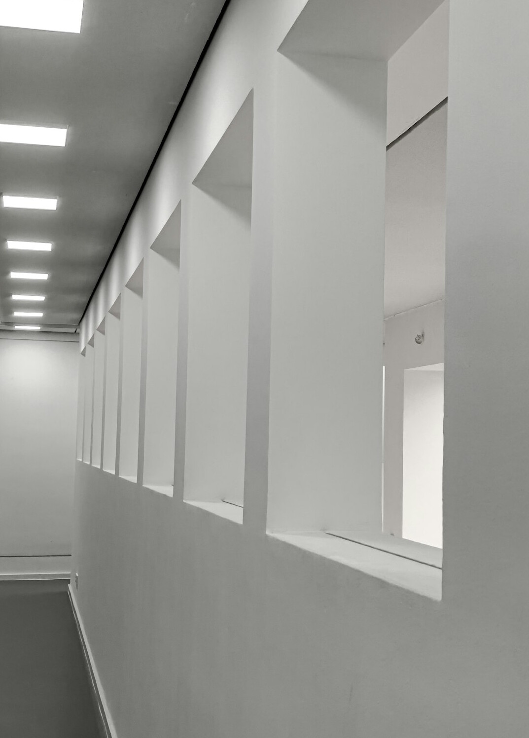 Long minimalist museum hallway with soft architectural light