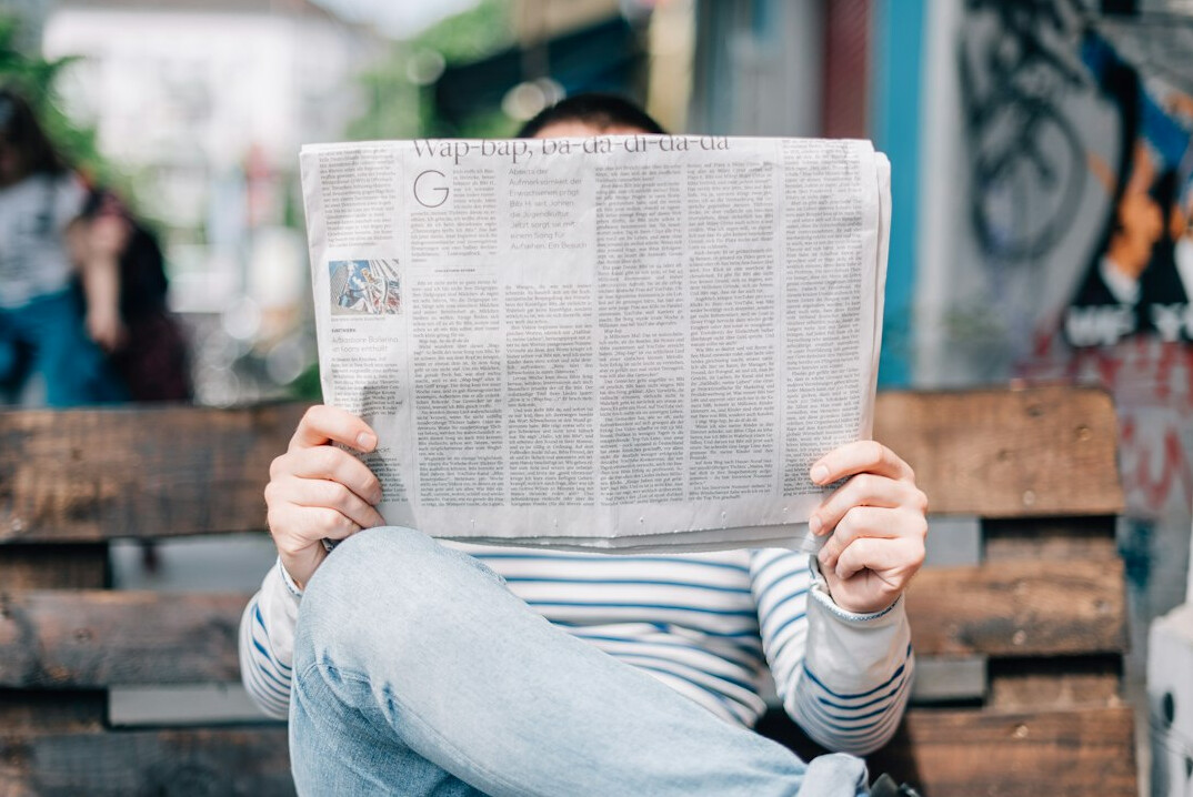 person reading newspaper